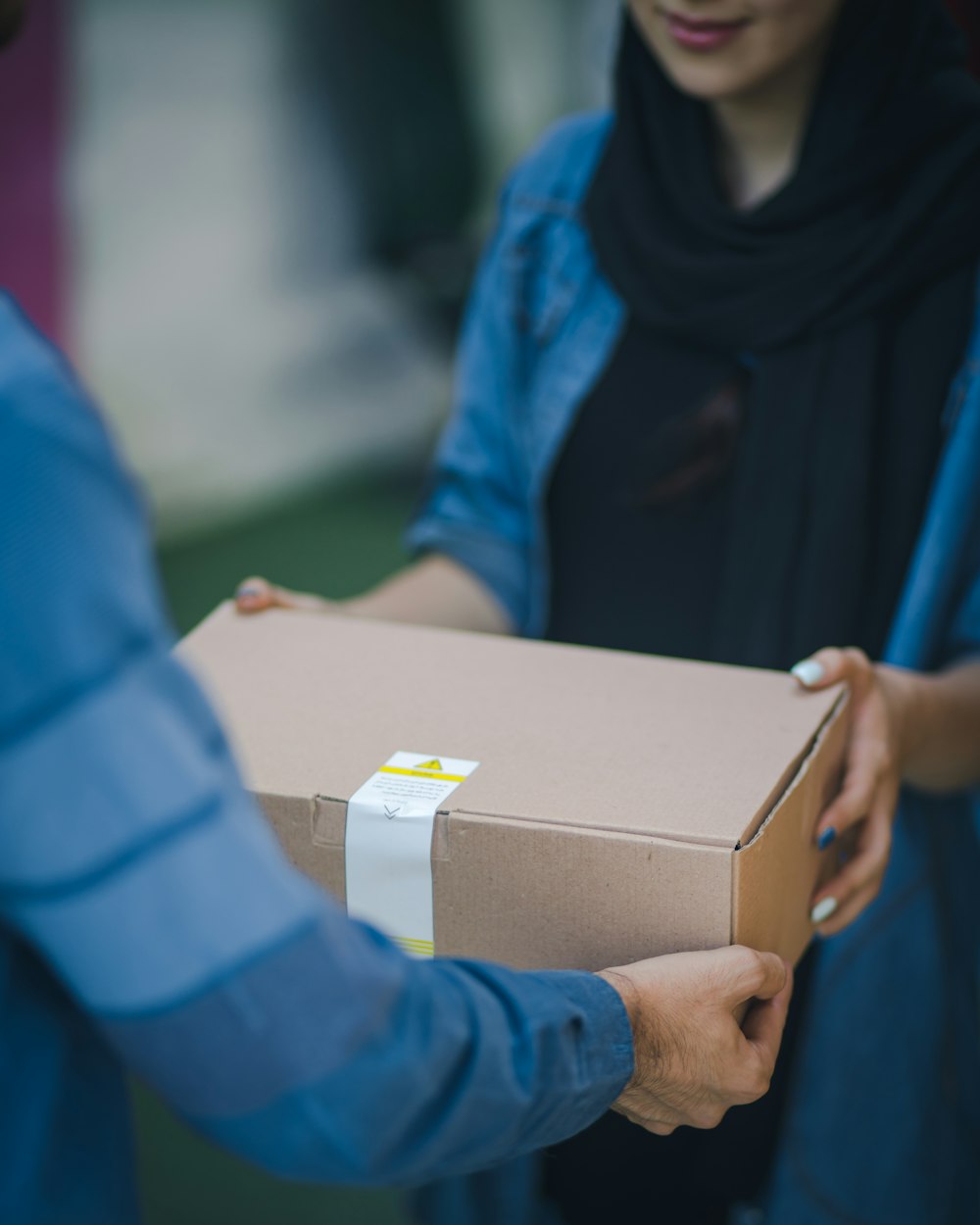 MCS Cargo courier handing a parcel to a customer